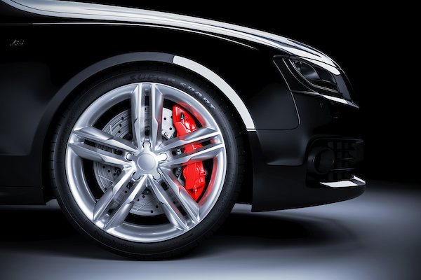 sports car wheel with red brakes